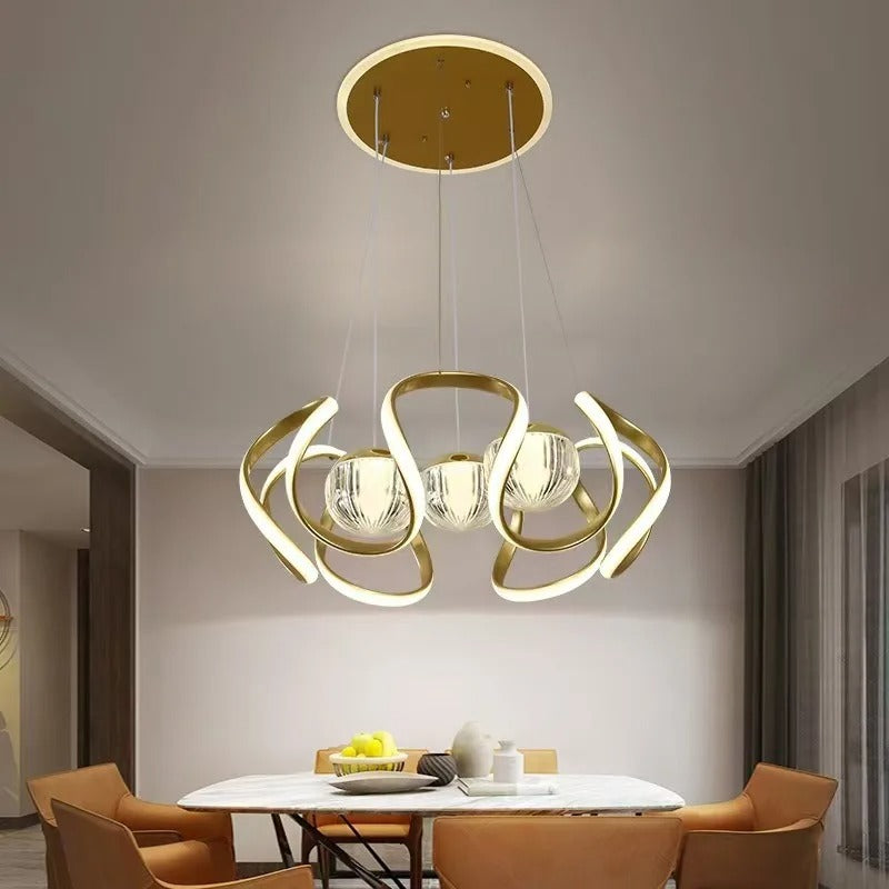 Gold-colored pendant lamp with curved frames and glass spheres