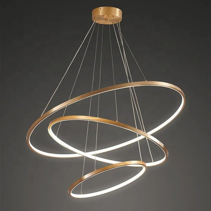 Gold-colored pendant lamp with three circular ring elements