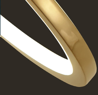 Gold-colored pendant lamp with three circular ring elements