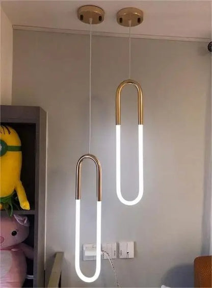 Gold-colored pendant lamp with two U-shaped glass elements